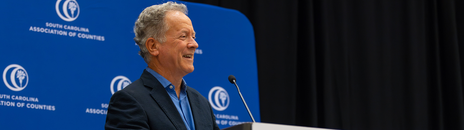 Former South Carolina Gov. David Beasley speaks at a podium during the 2024 SCAC Annual Conference.