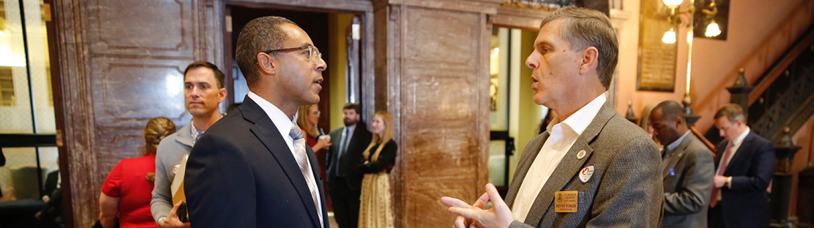 Sen. Kevin Reichenbach speaks with a county official during Counties Connect 2024.