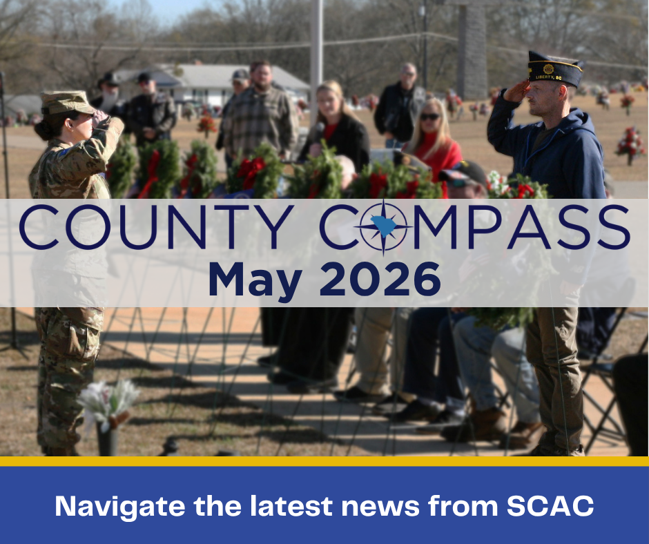 The County COMPASS logo is superimposed over a photo of military service members saluting.