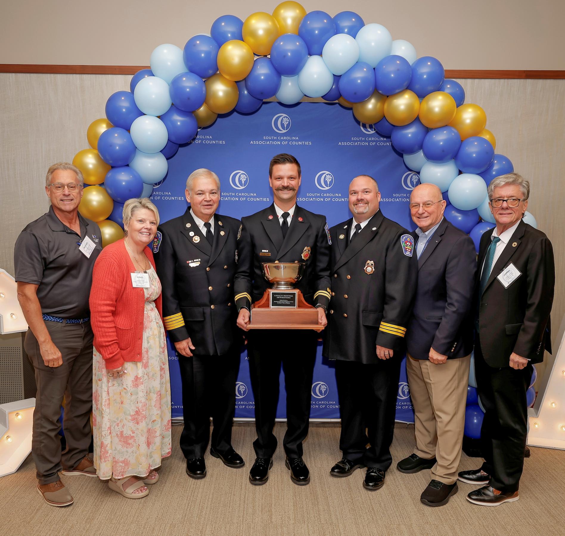 Members of Horry County Fire Rescue and Horry County representatives hold the J. Mitchell Graham Cup.