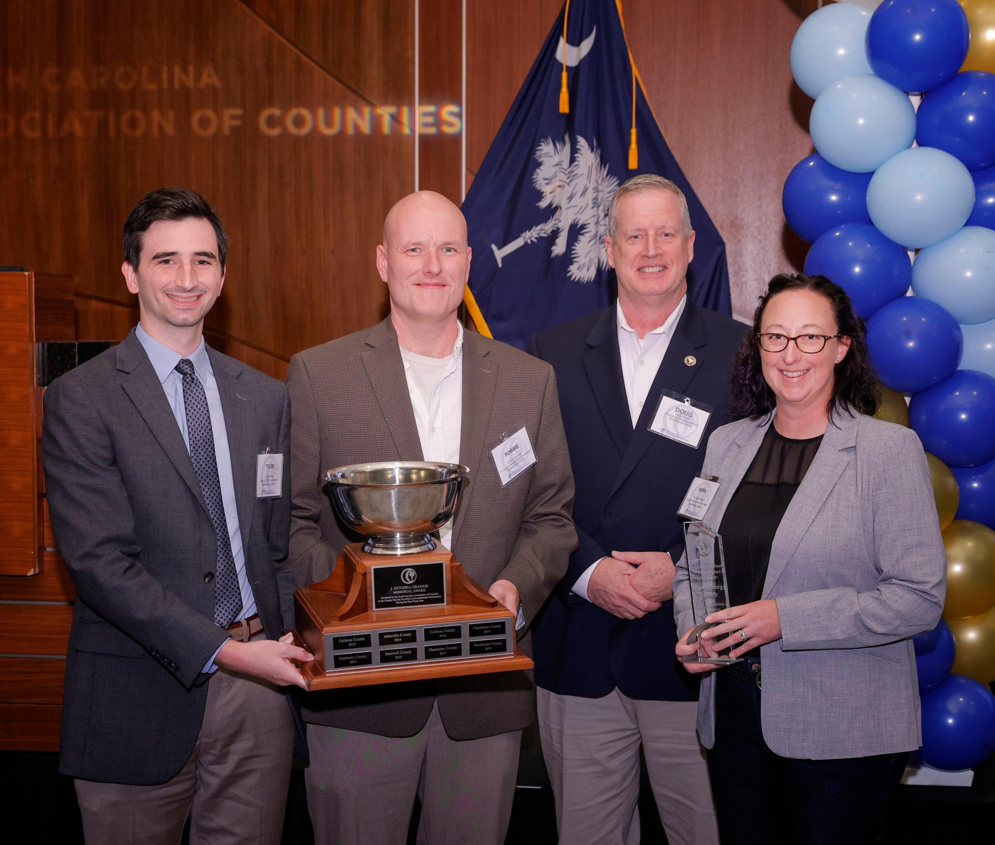 Representatives from Spartanburg County pose with the trophy for the 2025 J. Mitchell Graham Memorial Award.