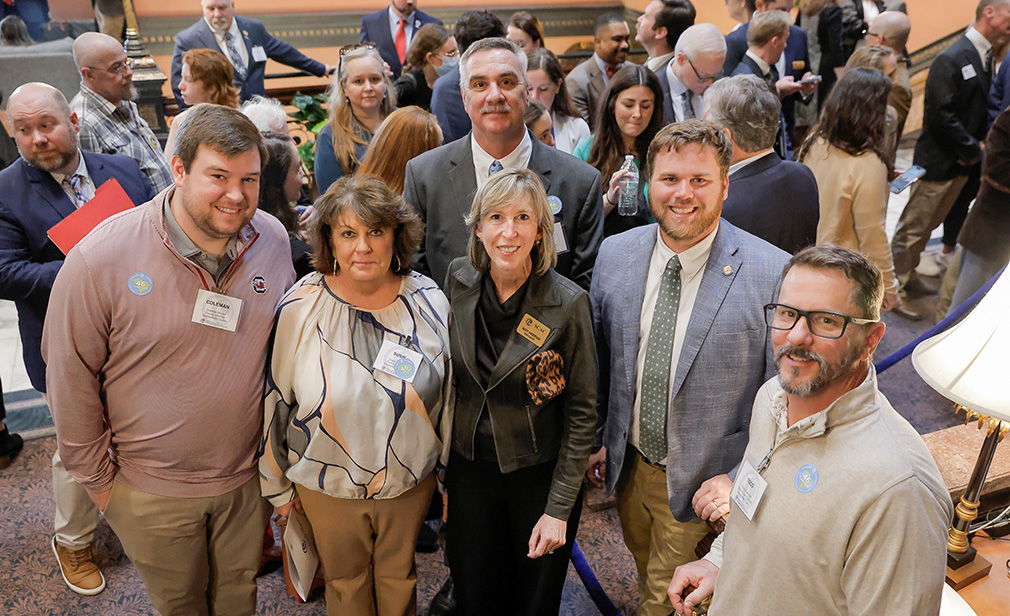 A group of people standing together in the South Carolina State House lobby.