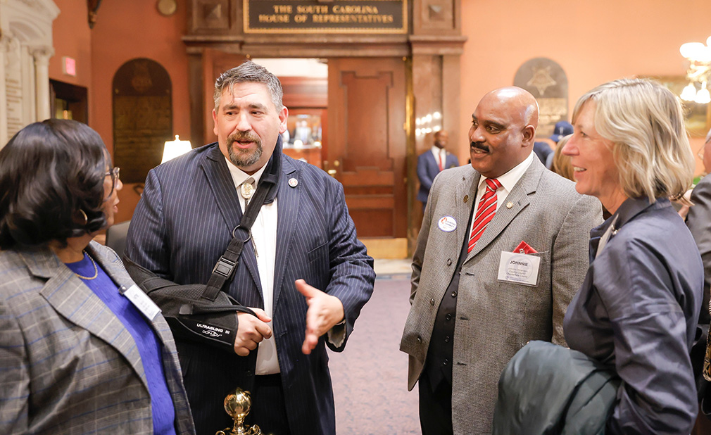 county representatives and state legislators meet in the State House lobby