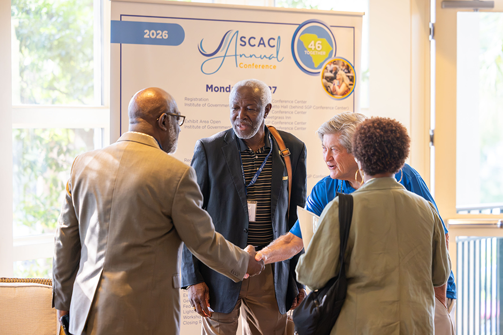 County officials network in front of annual conference agenda banner