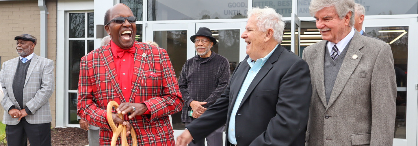 McCormick County Council Chairman Charles Jennings smiles at the crowd gathered for a ribbon cutting.