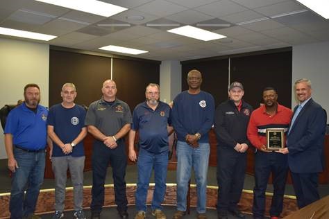 Frank Williams and local firemen accept Outstanding Safety Achievment award